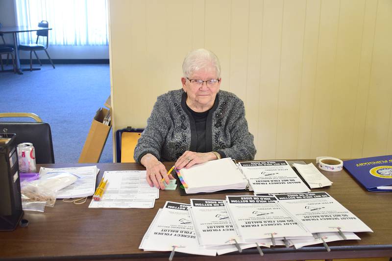 Lucille Reynolds waits to hand people their ballots at the Nov. 4 election.