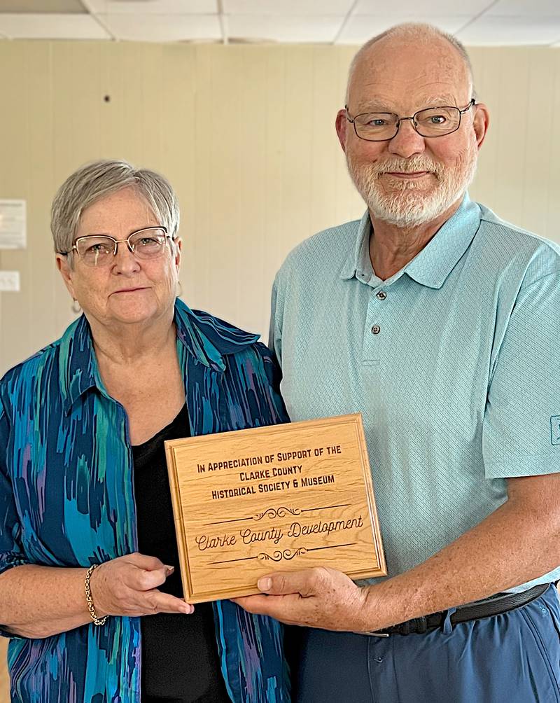 Clarke County Historical Society President, Phyllis Paul presents the honorary plaque to CCDC Board President, Kevin Emanuel.