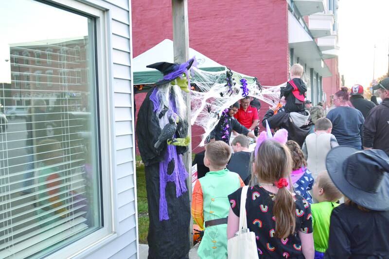 Kids line up to receive candy at last year's Downtown Spooktacular.