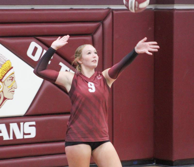 Mylee Miller reaches back to serve the ball.