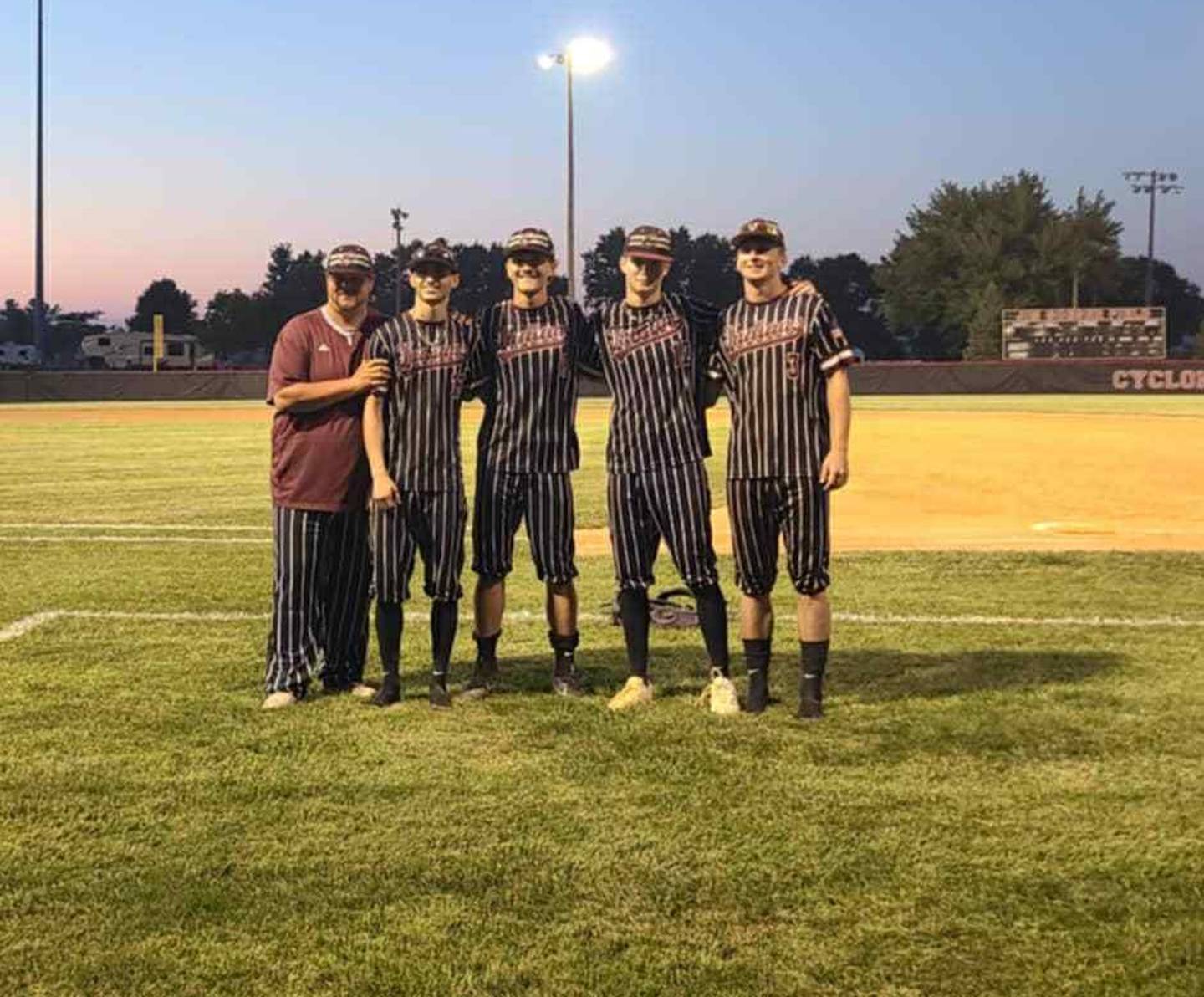 Clarke baseball seniors pose with head coach Jeff Giza after their final game of their high school career. From left, Giza, Deegan Neese, Eli Fry, Seth Oswald and Brock Watson.