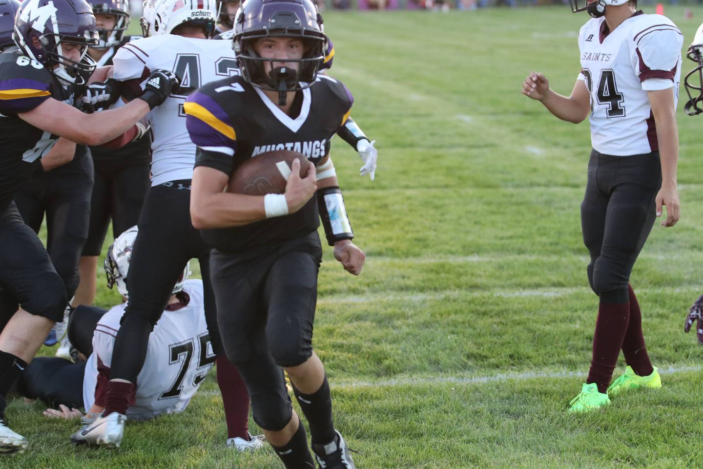Keegan Chew carries the ball past Melcher-Dallas defense.