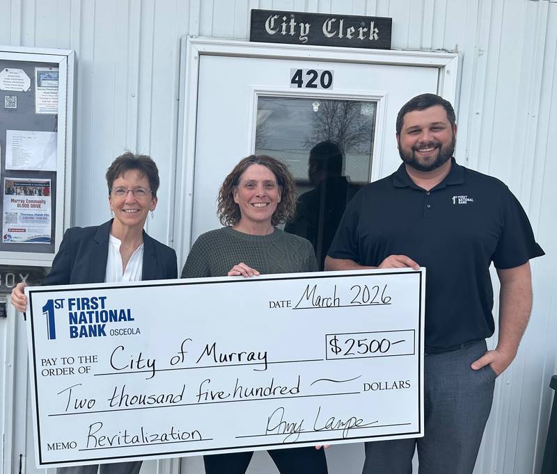 DONATION: Murray City Administrator Denise Arnold (center) accepts a checks from First National Bank representatives Amy Lampe (left) and Jeremy Evers (right) to go towards Murray’s revitalization project.
