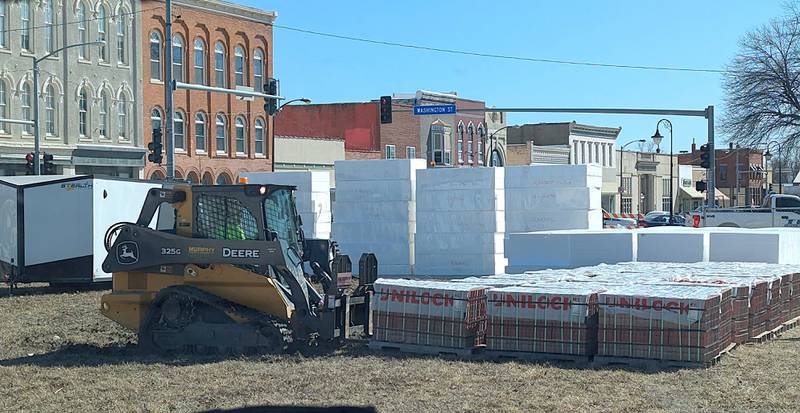 Crews unload the pavers that will be installed on the downtown streets