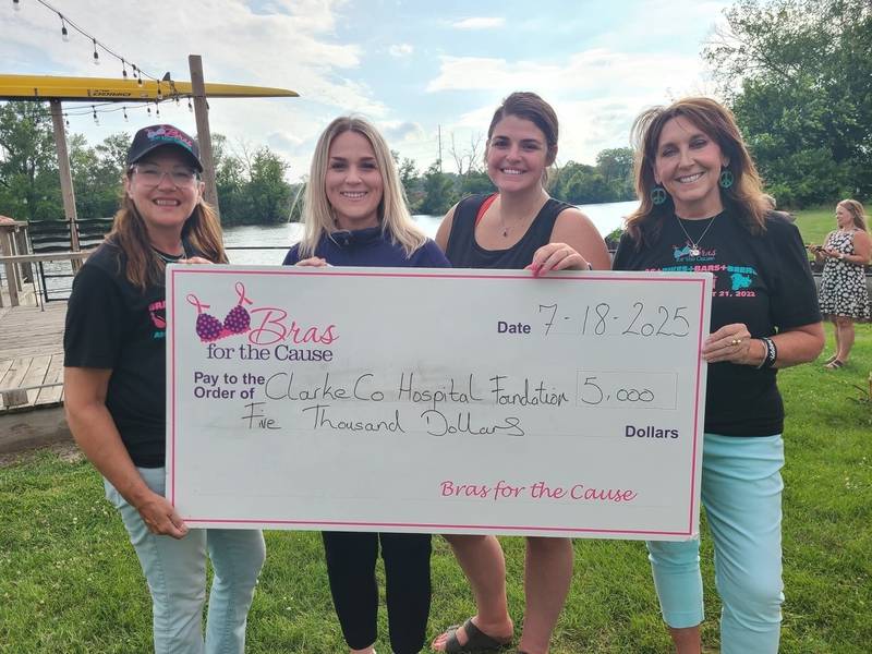 Representatives of Clarke County Hospital accept a donation from the Bras for the Cause Foundation.