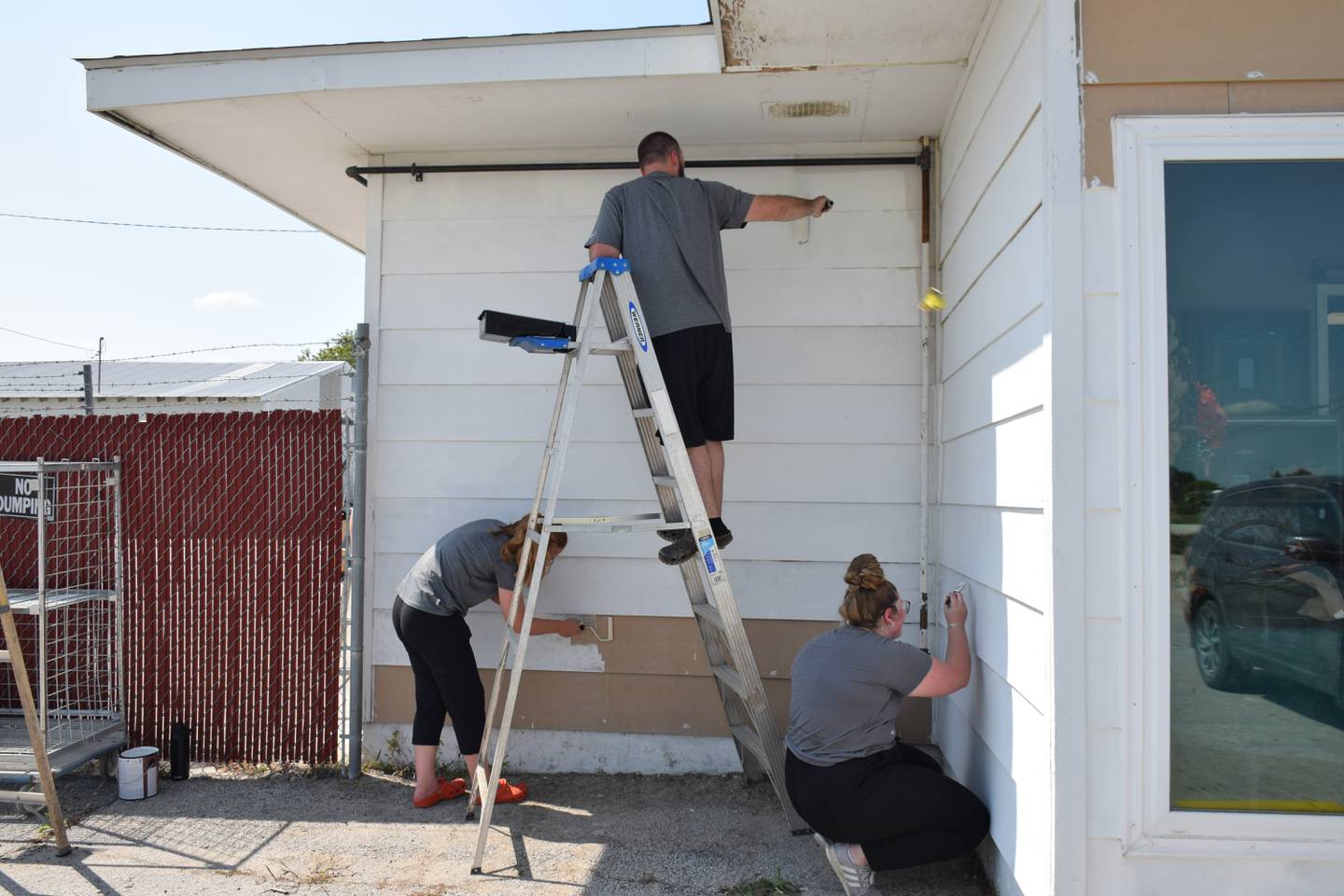 In a small spot of shade are Stephanie Howard, Spencer Chapman and Karley Mart.