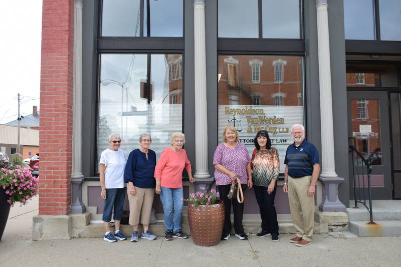 Pictured from left to right are Kay Chaney, Marie White, Connie Curnes, Suzanne Williams, Jan Opferman and Bob Reynoldson stand outside 200 W. Jefferson St.. Opferman’s third great-grandfather built the building that Reynoldson owns and practices law out of today.