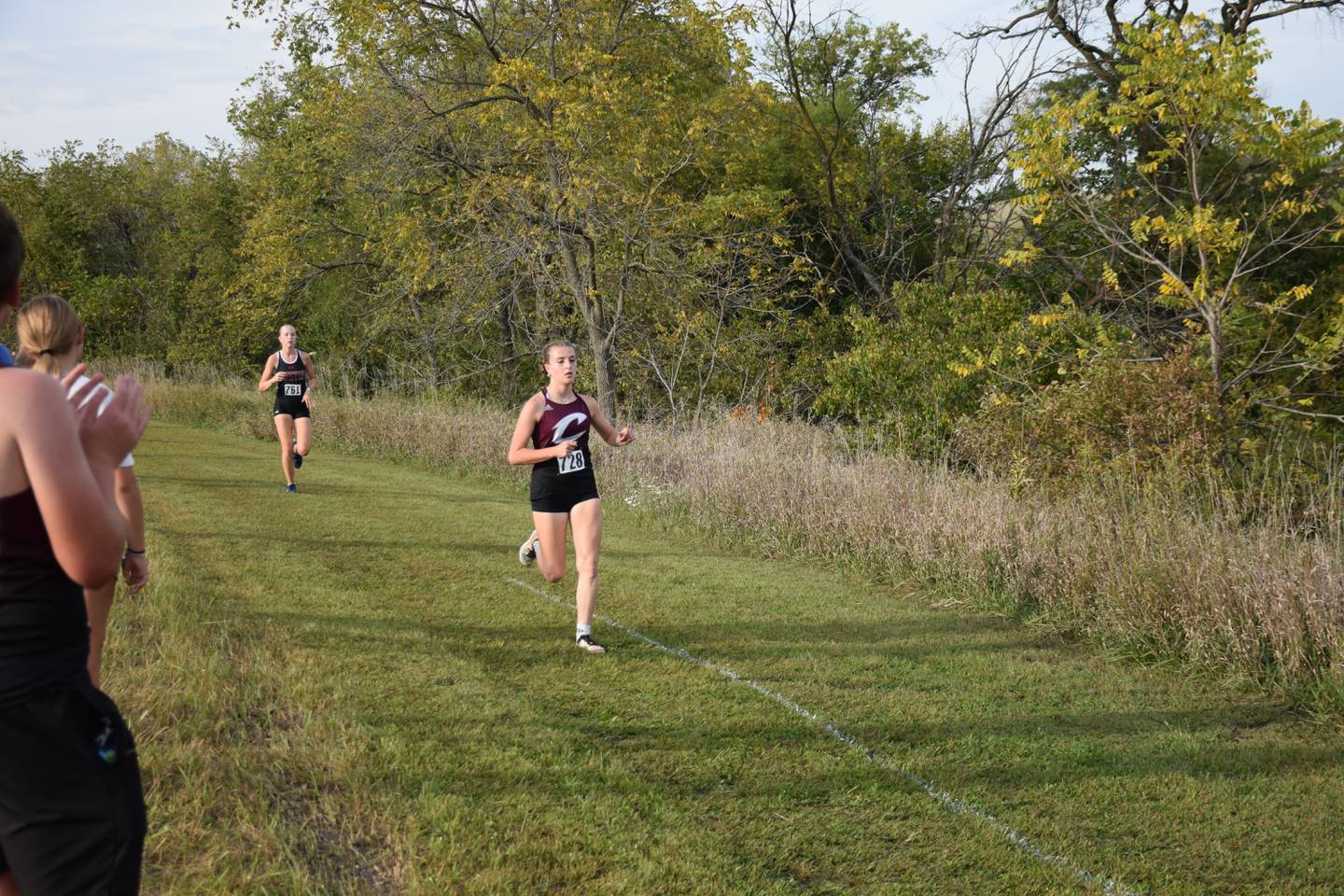 Izzy Hay runs the first leg of Clarke's home cross country meet.