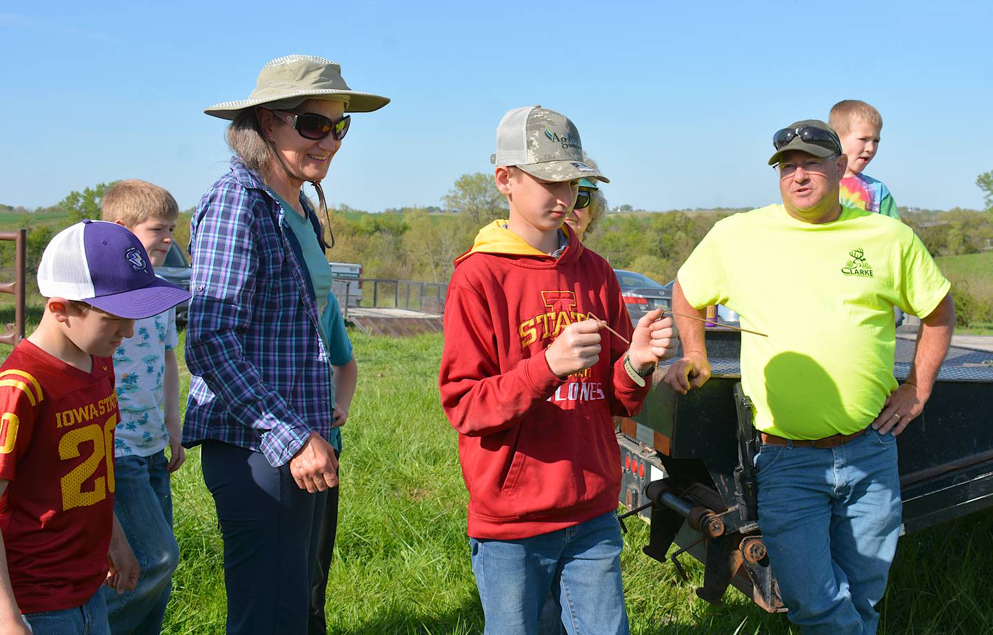 A youth learns how to use dowsing rods. The rods are use electromagnets to find  places where the land has been disturbed at one time, such as where objects have been buried or to find water underground.