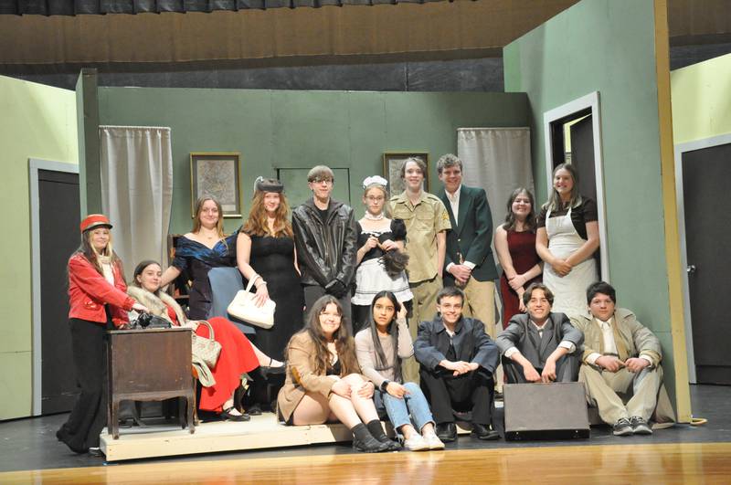 The cast of 'Clue' pose in the library during rehearsals.