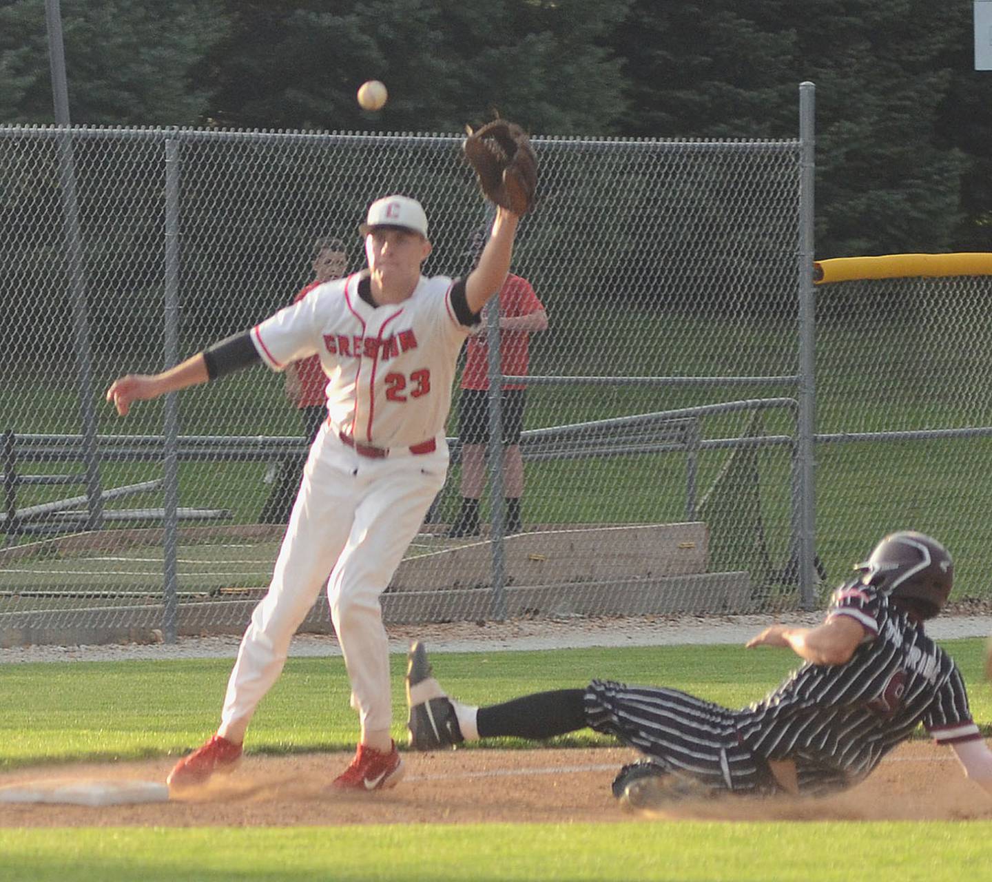 Clarke's Eli Fry slides safely into third base with a stolen base in Clarke's 6-1 victory July 11, 2025 at Creston.