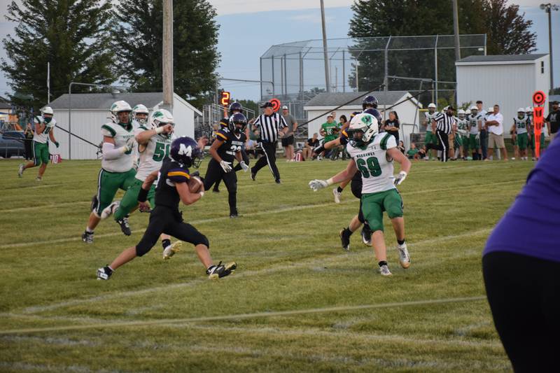 Southeast Warren’s Lucas Dirkx (69) looks to stop Murray’s Keegan Chew from getting the first down at Murray’s week one home game last Friday.