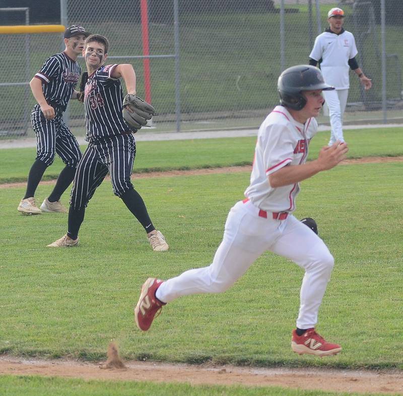 Clarke pitcher Bryce Giza throws to first base on a Creston sacrifice bunt by Tyler Riley during Clarke's 6-1 victory at Creston July 11, 2025.
