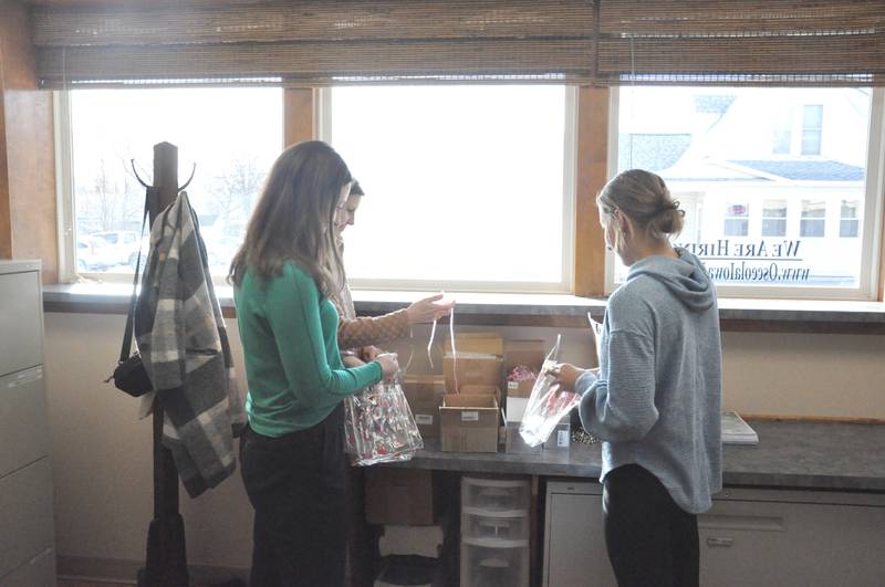 Clarke student intern Tory Henry, right, helps OCMS events coordinator Cady Atwood (green shirt) and OCMS executive director Ashleigh Eckels fill bags for the Chamber’s ‘Sips ‘n Sweets’ event. Tory is spending the semester interning at OCMS.