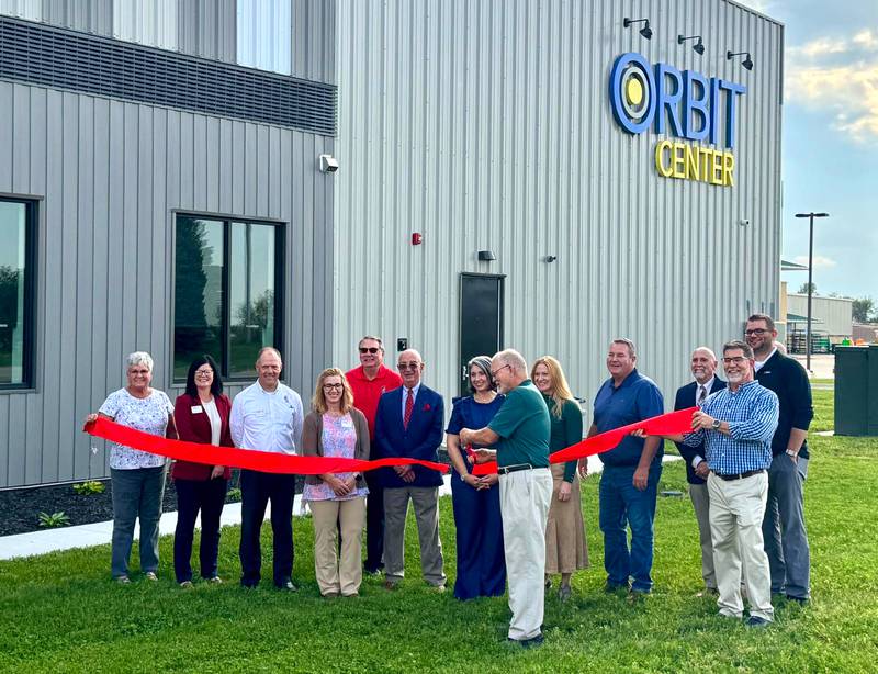Clarke County Development Corporation Board President Kevin Emanuel cuts the ribbon at the ORBIT Center’s grand opening Oct. 17. From left: Sue Wilder, CCDC board member; Lindsey Stoaks, SWCC president; Wayne Pantini, SWCC vice president of economic development; Tisha Gannon, SWCC Osceola center coordinator/CCDC board member; Dr. Tony Cass, SWCC board president; Bill Trickey, former CCDC executive director; Liz Simpson, former CCDC program manager; Emanuel; Sen. Amy Sinclair; Brian Crawford, DENOVO COO; Dave Opie, CCDC board member; Andrew B. Clark, CCDC executive director and Nathan Grismore, CCDC board member.