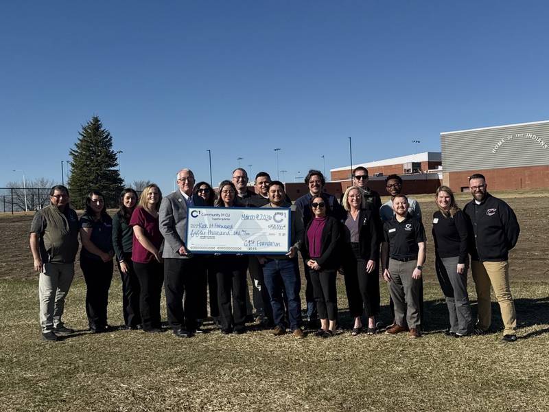 Members of Community 1st Credit Union present a $50,000 check to representatives of the City of Osceola for the mini pitch project.