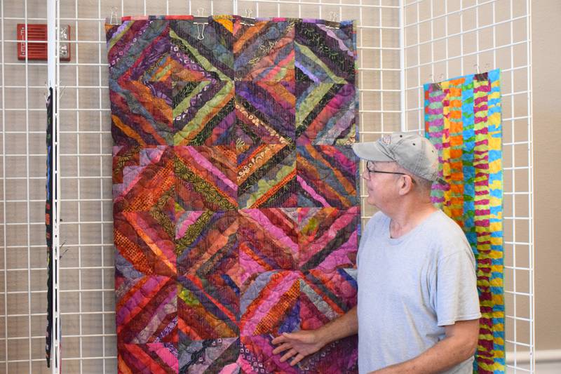 Clarke Area Arts Council featured artist of the month John Willcox talks about one of his many quilts on display now through Oct. 4 at Lakeside Hotel Casino.