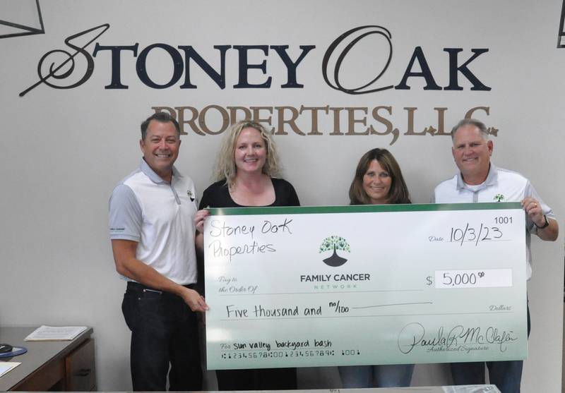 L-r: Tim Mauro, Family Cancer Network, Katie Almeida, Family Cancer Network, Paula McClaflin, Stoney Oak Properties and Mike Biegger, Family Cancer Network, stand with McClaflin's $5,000 match check.